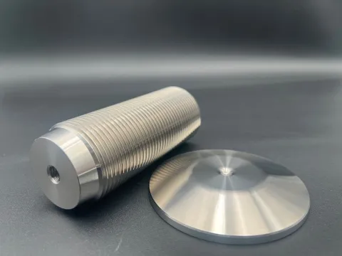 Close-up of a precision machined aluminum audio component showing clean surfaces and controlled edge quality