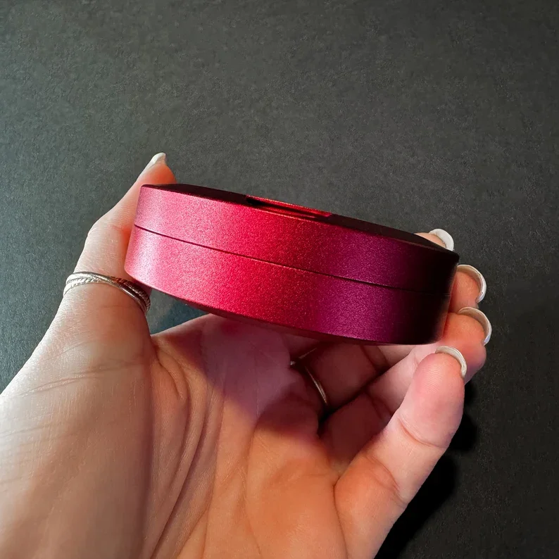 A collection of high-precision red metal snus cans with lids. A collection of high-precision red metal snus cans with lids, showcasing their quality finish.