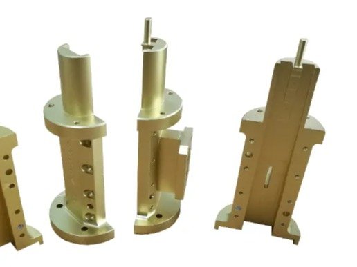 Gold anodized CNC components demonstrating surface finish technologies for industrial parts