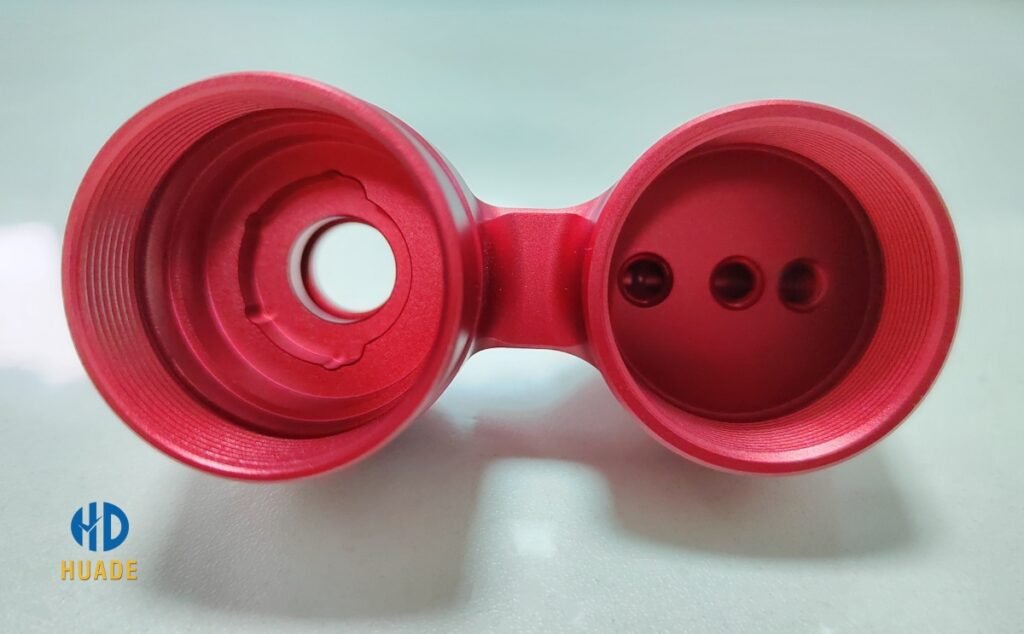 Red Anodized CNC Part – Surface Finishing Example CNC anodized aluminum part with red coating showing advanced surface finishing technologies