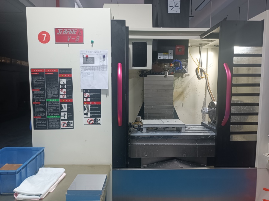 High-precision 4 axis CNC machine performing multi-side metal milling with rotary A-axis for complex part manufacturing.