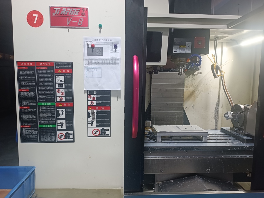 Advanced 4 axis CNC machines in a modern workshop, featuring multiple rotary tables for simultaneous multi-axis machining of precision components.