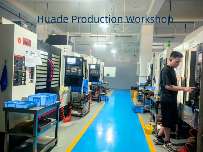Worker operating a high-precision CNC machine in Huade Production Workshop, highlighting advanced CNC machining services at the new Gaobu CNC facility.