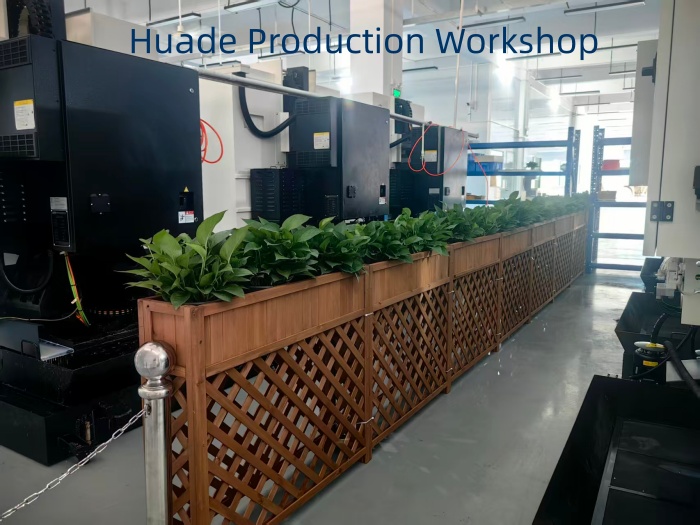 Huade Production Workshop featuring multiple CNC machines and green plants, emphasizing sustainable and efficient custom CNC parts production in Gaobu.