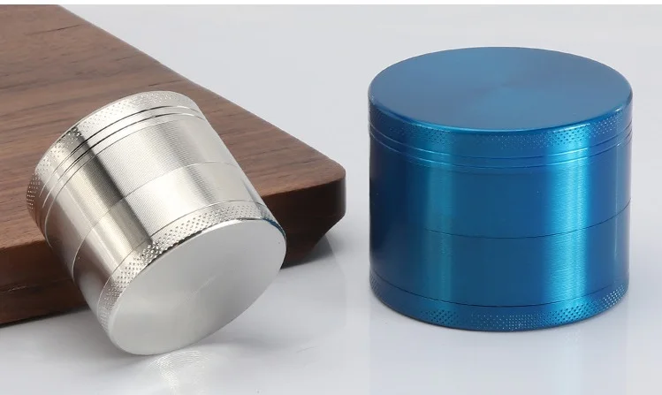Two premium CNC machined aluminum herb grinders in silver and blue matte finish.