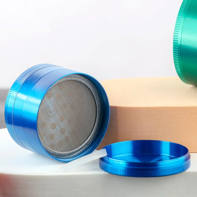 Custom blue anodized tobacco grinder with metal mesh screen detail