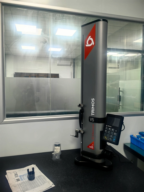 Digital height gauge measuring CNC machined parts
