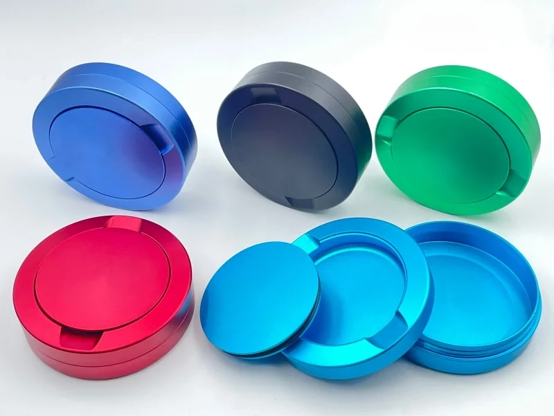 Anodized aluminum snus cans in multiple colors showing CNC machining customization options