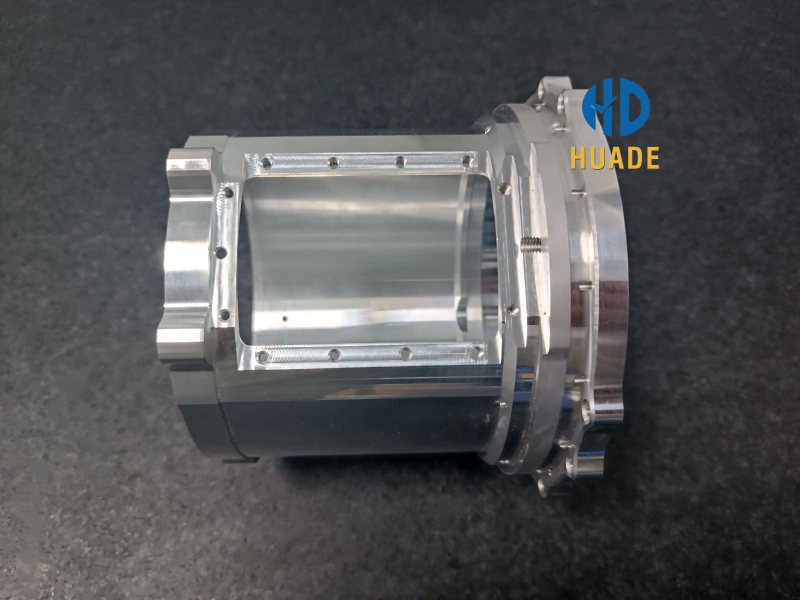 An isometric view of a standing aluminum alloy forging showing complex side cutouts and internal circular bores machined to tight tolerances.